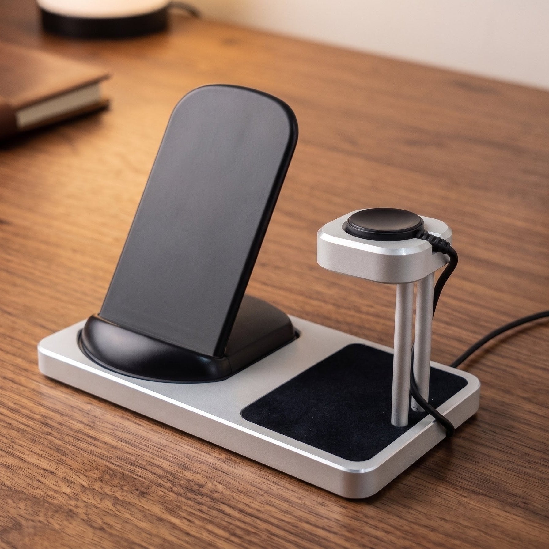 Multi-device charging station on a wooden desk with a phone, watch, and cable.