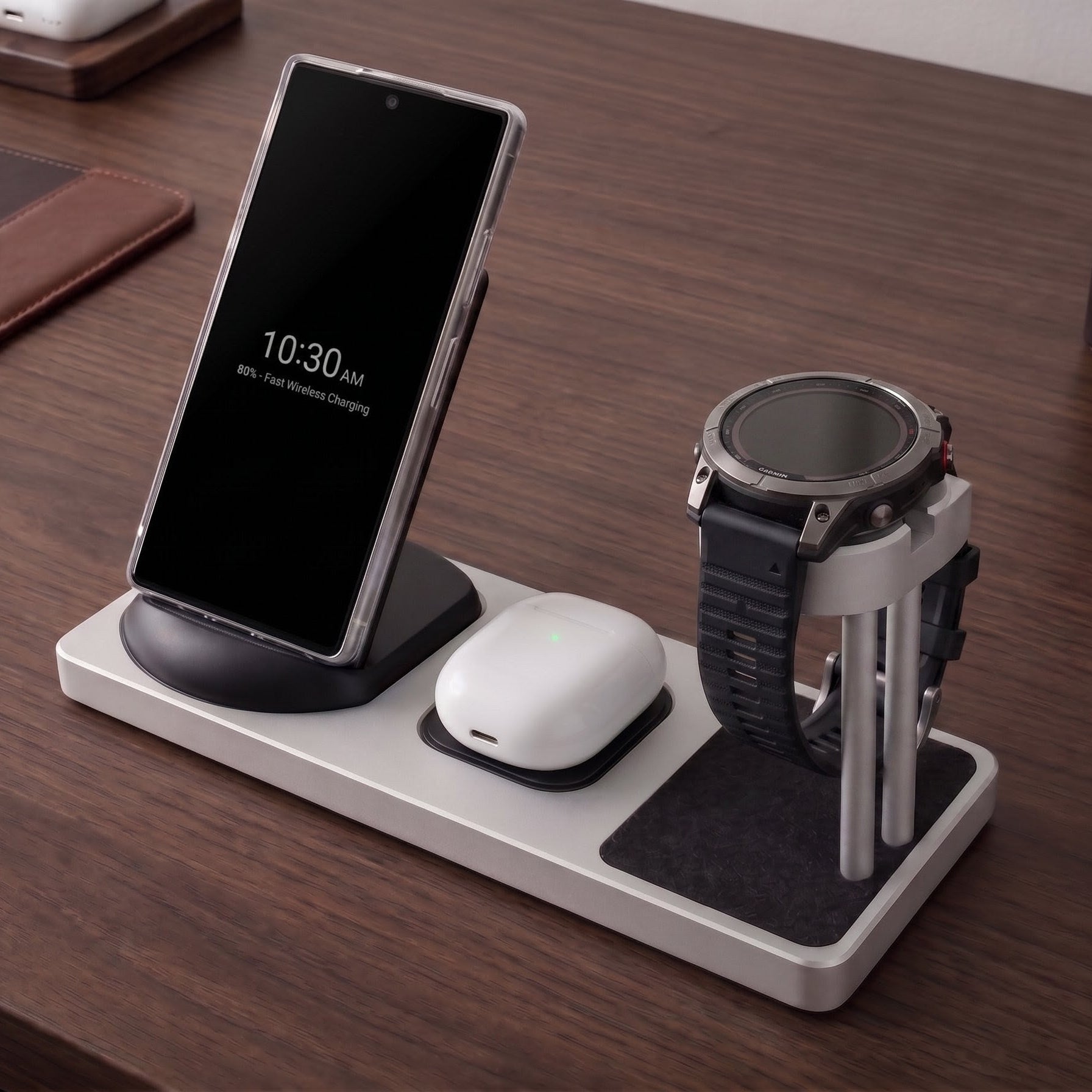 Multi-device charging station on a wooden desk with smartphone, smartwatch, and mouse.