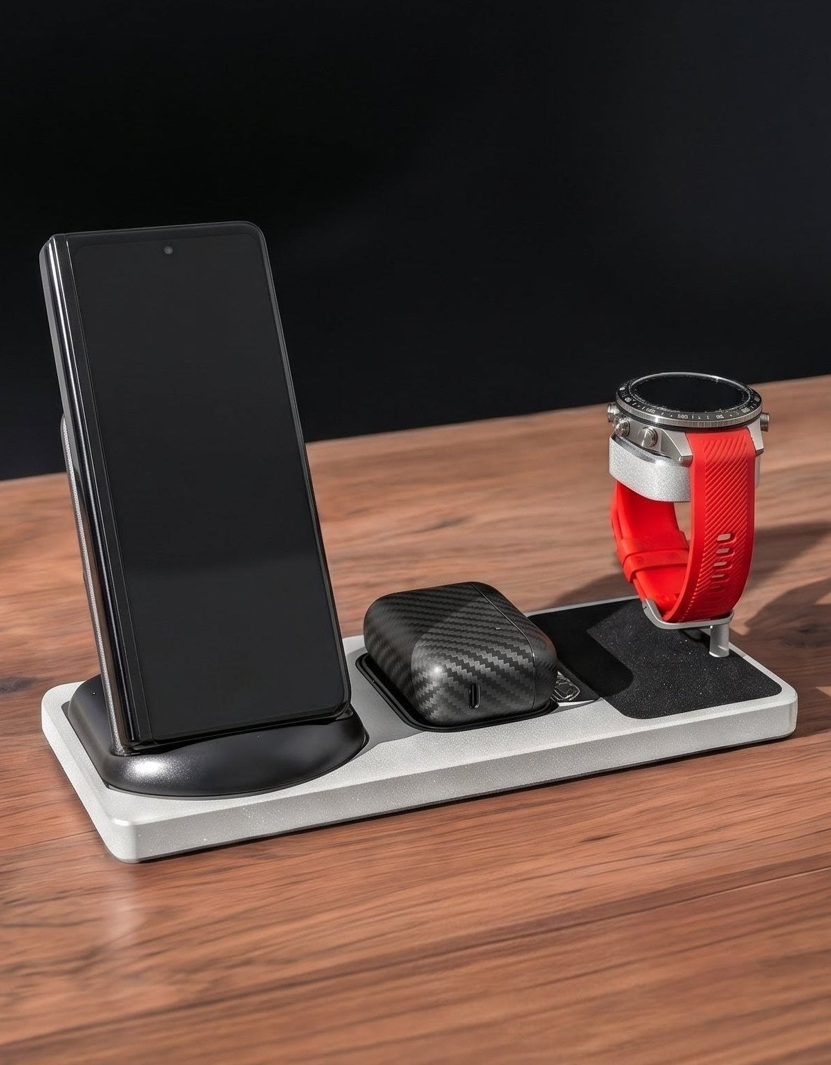 Multi-device charging station with smartphone, smartwatch, and wireless chargers on a wooden surface.