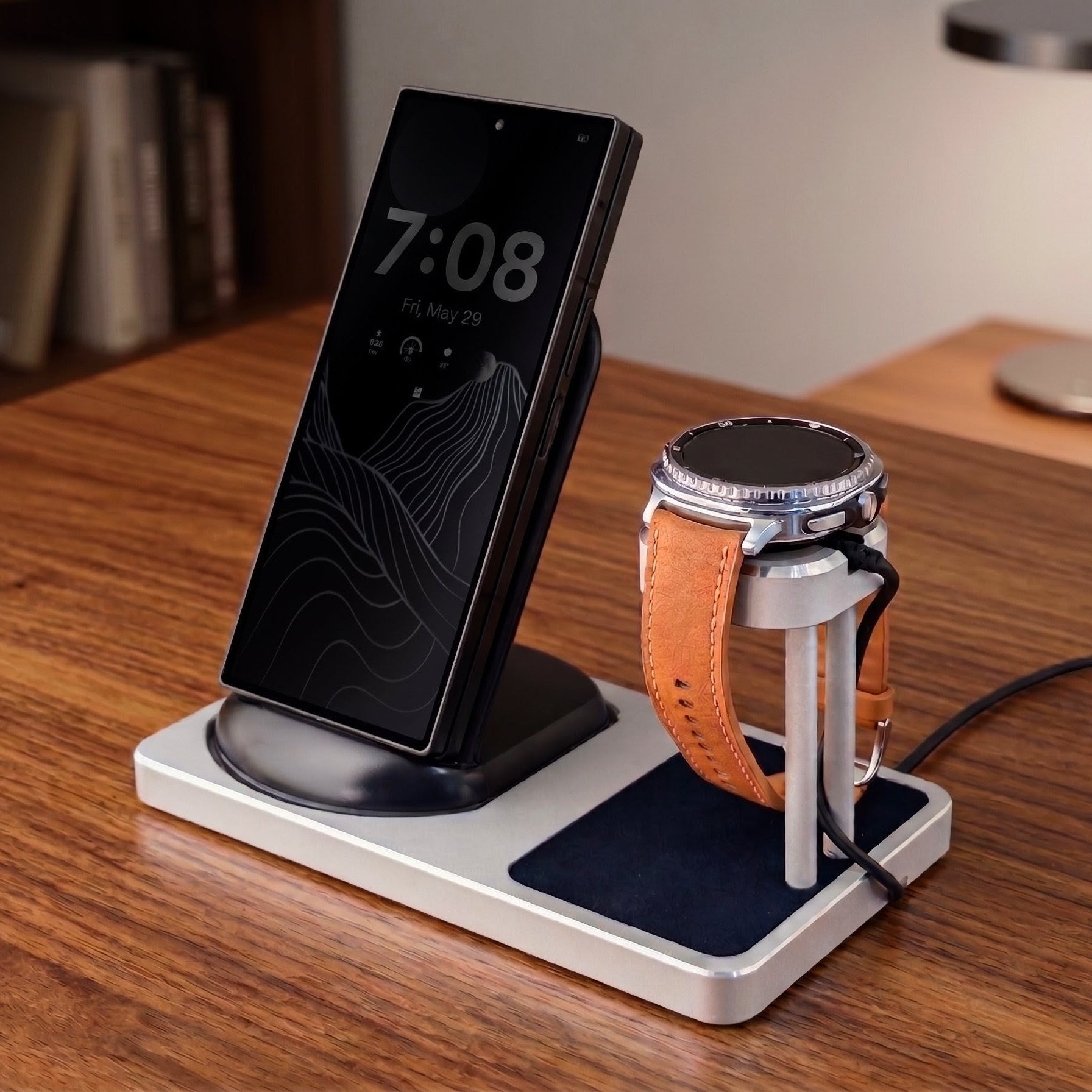 Wireless charging stand with smartphone and smartwatch on a wooden surface