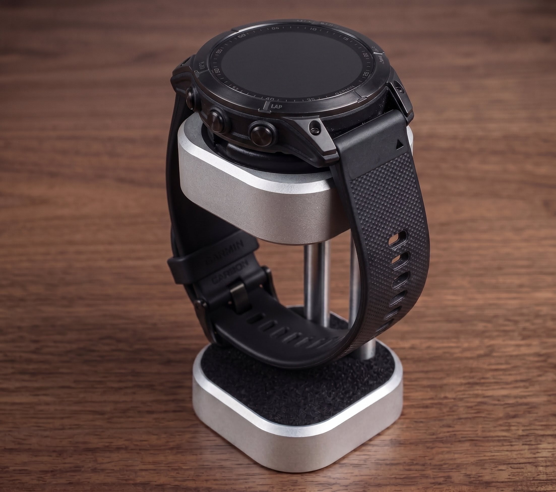 Smartwatch on a stand with a wooden background