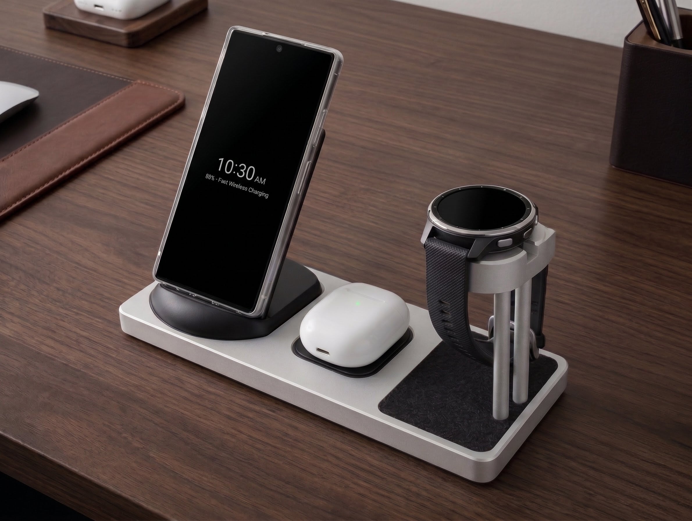 Desk organizer with smartphone, smartwatch, and wireless earbuds on a wooden surface
