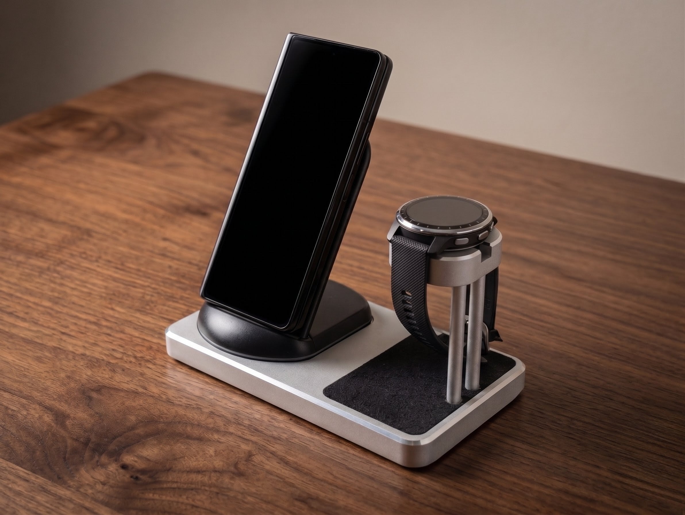 Multi-device charging stand with smartphone, smartwatch, and wireless charger on a wooden surface.